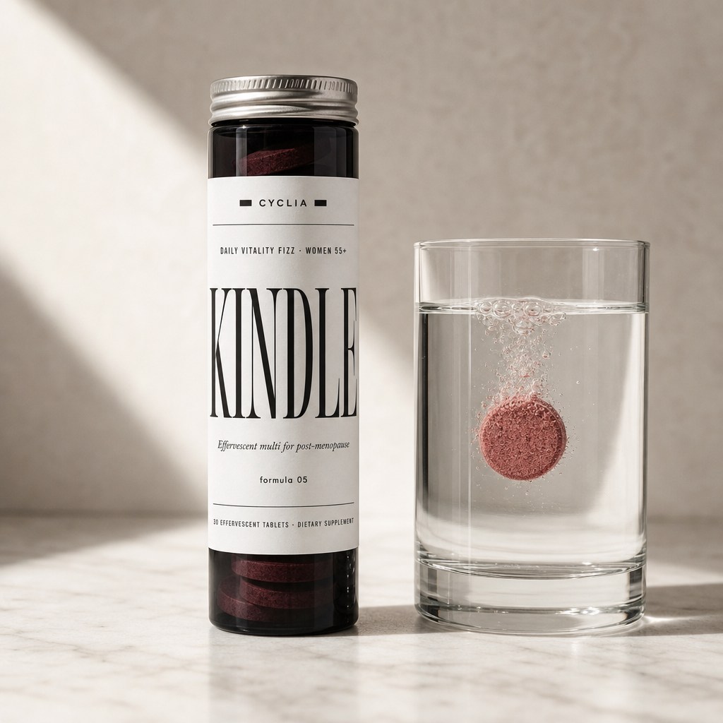 A tube of Kindle daily fizz tablets beside a glass of fizzing water