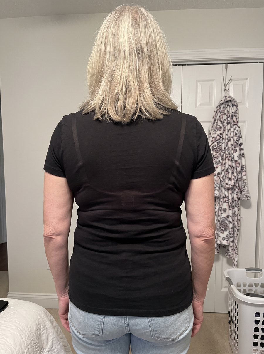Patricia H. from behind in her usual bra: a band line and roll show through the top