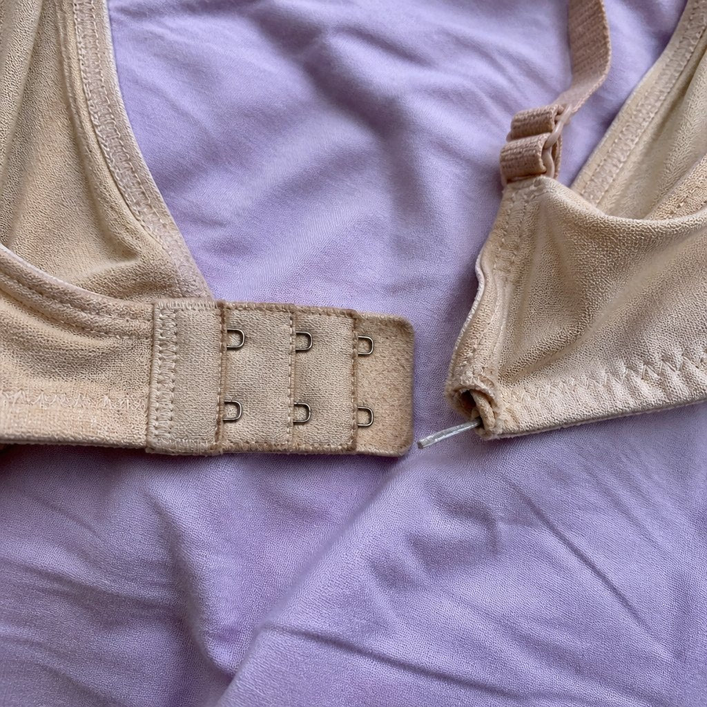 A bra's metal hook clasp and a poking underwire