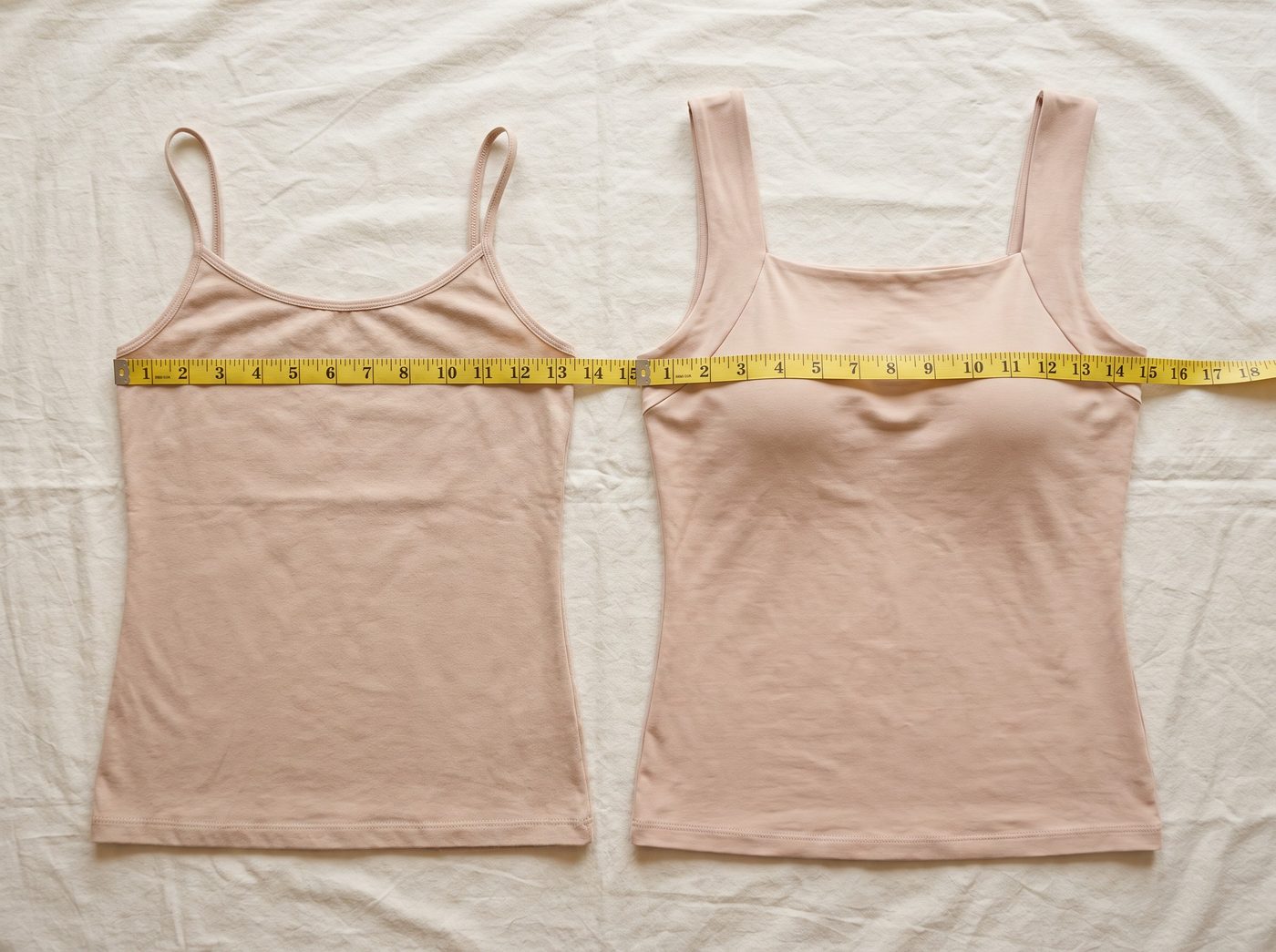 Two tanks laid flat with tape measures across the chest
