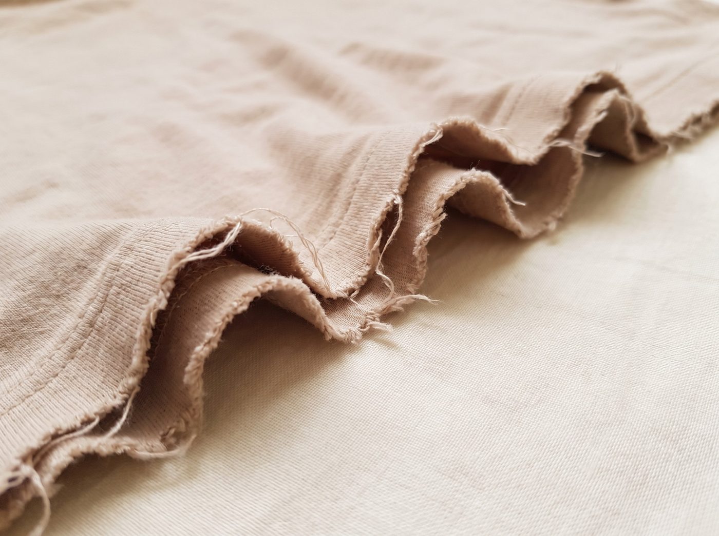 A raw cut edge curling up