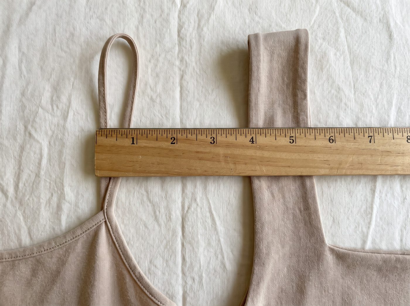 A ruler across a thin strap and a wide strap